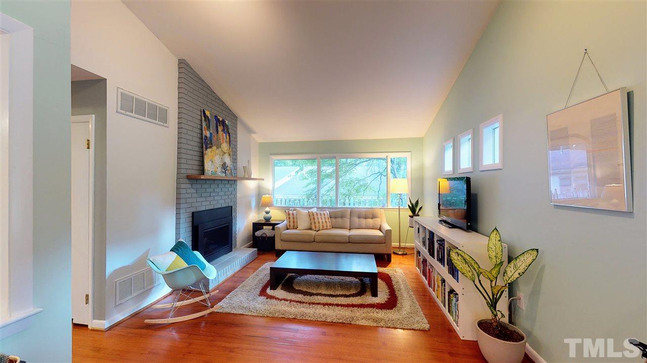 4212 Windsor Place Raleigh, NC 27609 - Photo 16 of 30 a living room with furniture fireplace and a window