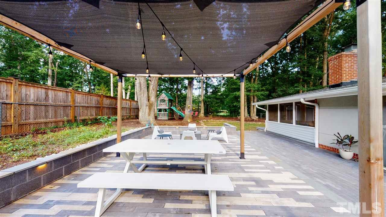 4212 Windsor Place Raleigh, NC 27609 - Photo 3 of 30 a view of a patio with table and chairs potted plants with wooden floor and fence