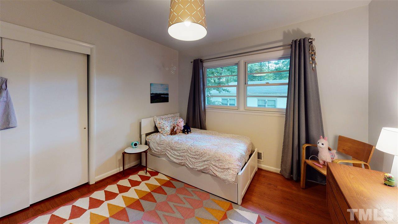 4212 Windsor Place Raleigh, NC 27609 - Photo 22 of 30 a bedroom with a bed and wooden floor
