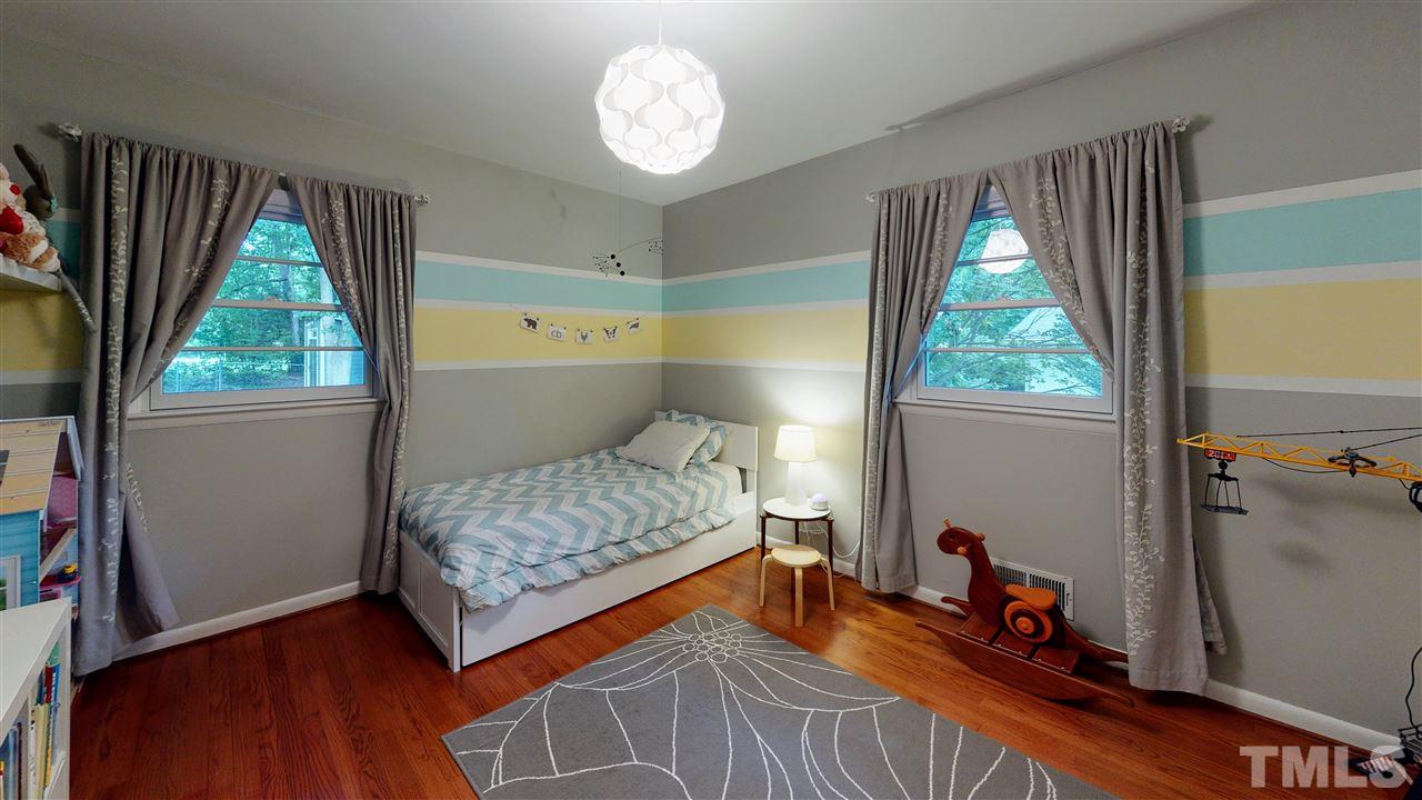 4212 Windsor Place Raleigh, NC 27609 - Photo 23 of 30 a bedroom with a bed and a window