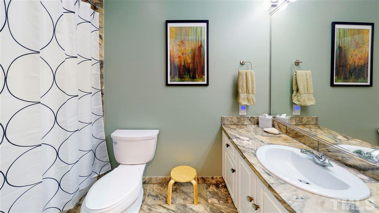 4212 Windsor Place Raleigh, NC 27609 - Photo 24 of 30 a bathroom with a granite countertop toilet sink and mirror