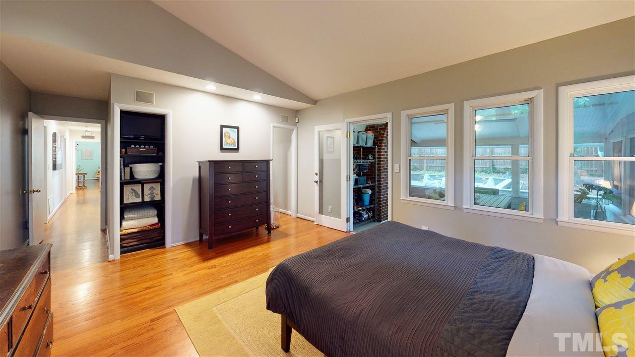 4212 Windsor Place Raleigh, NC 27609 - Photo 10 of 30 a bed room with a bed and dresser with mirror