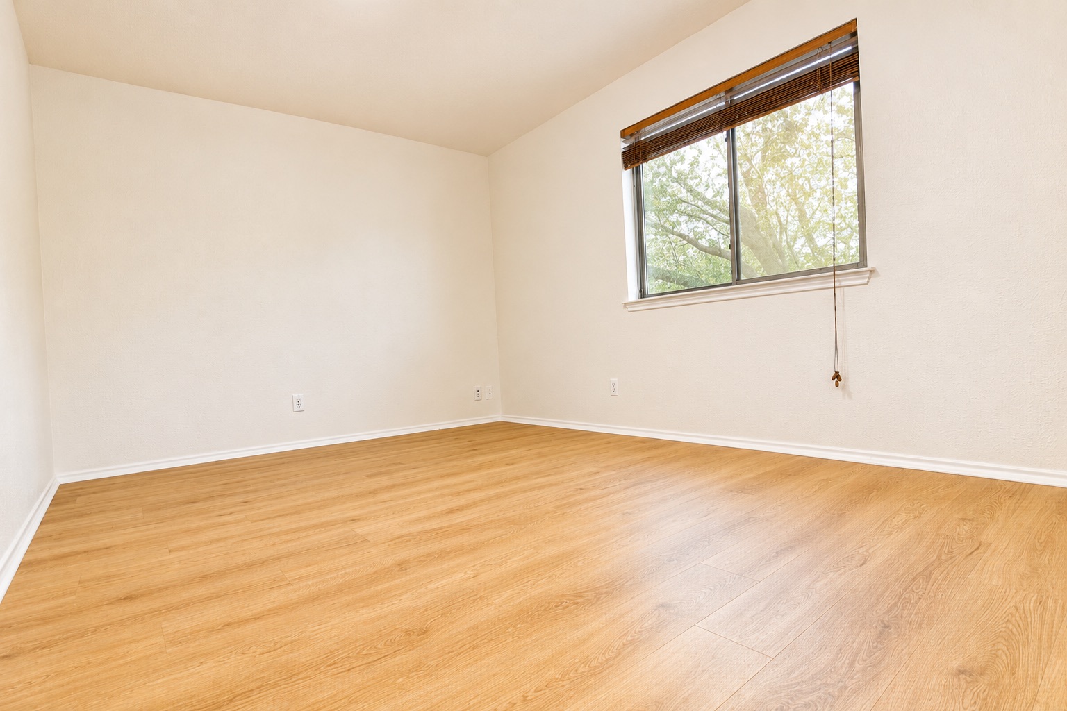 8807 Springmail Circle, Unit A Austin, TX 78729 - Photo 31 of 40 Bright, airy space features beautiful wood flooring and a view of lush greenery outside.