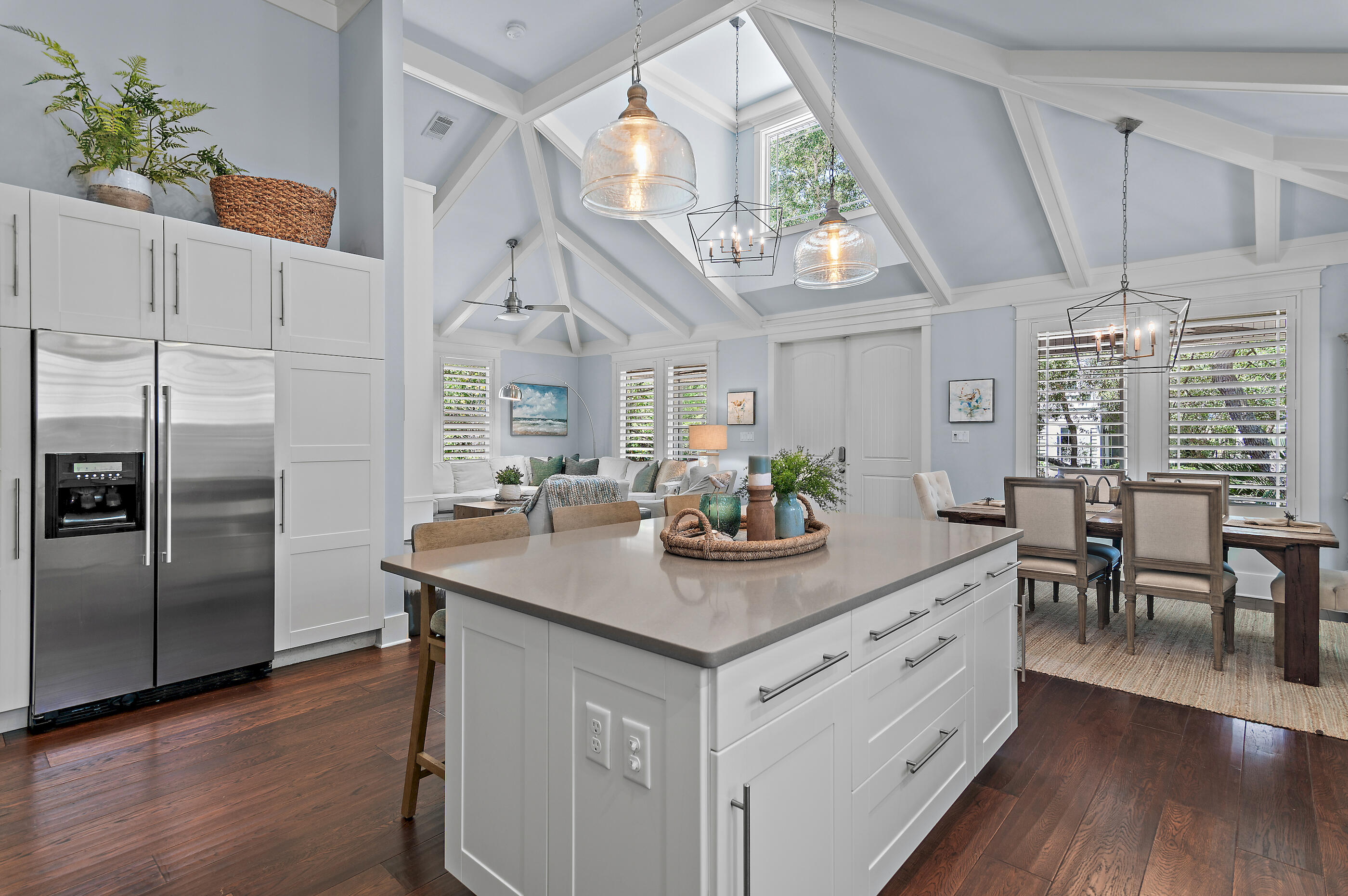 104 Spotted Dolphin Road Santa Rosa Beach, FL 32459 - Photo 14 of 42 a kitchen with stainless steel appliances kitchen island granite countertop a table chairs and wooden floor