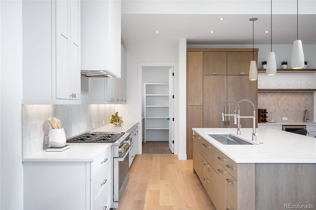 a kitchen with a sink stove and cabinets