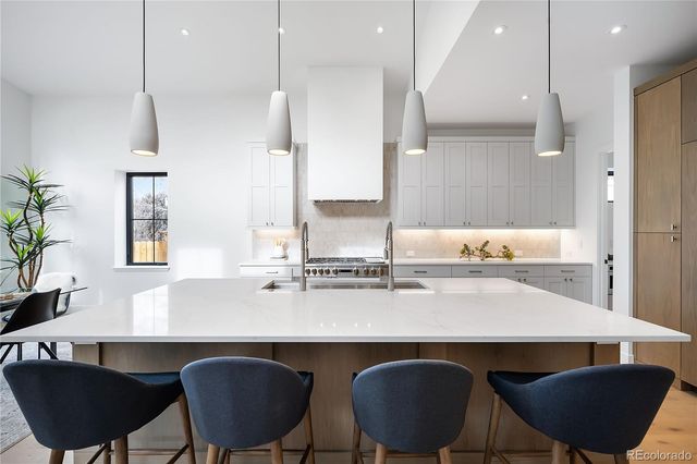 a kitchen with a table chairs sink and cabinets