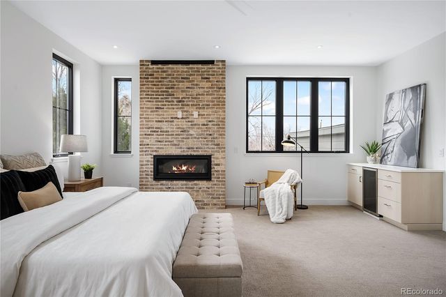 a bedroom with furniture and a fireplace