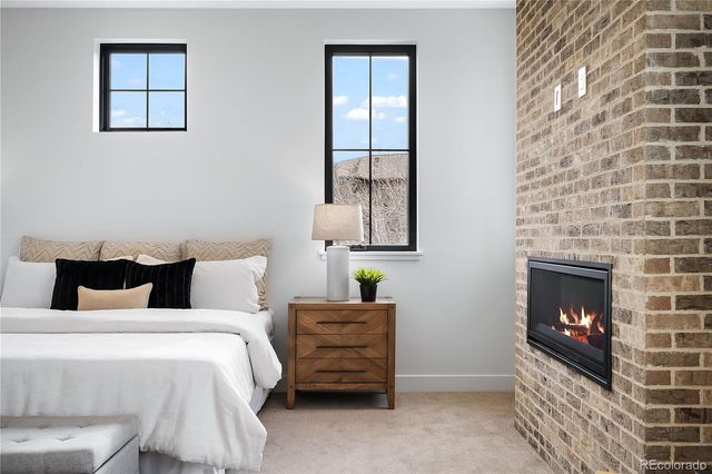 a bedroom with a bed and a fireplace