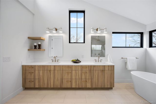 a bathroom with a sink mirror and a bathtub