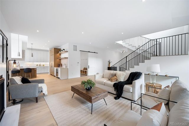a living room with furniture and kitchen view
