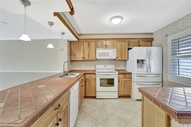 a kitchen with a stove sink and cabinets