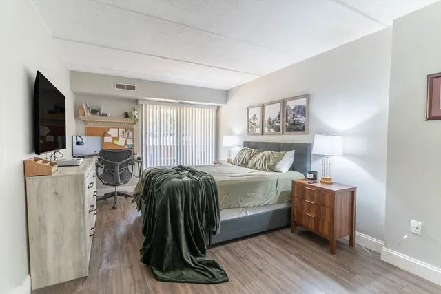 a bedroom with a bed and a large window