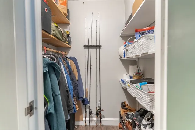 a view of walk in closet with clothes and shoes