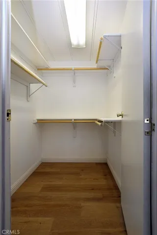 a view of storage and utility room with wooden floor