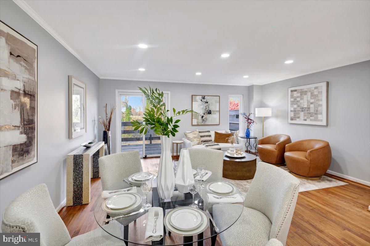 12 Stone Ridge Court Baltimore, MD 21239 - Photo 11 of 38 a dining room with furniture a potted plant and a painting