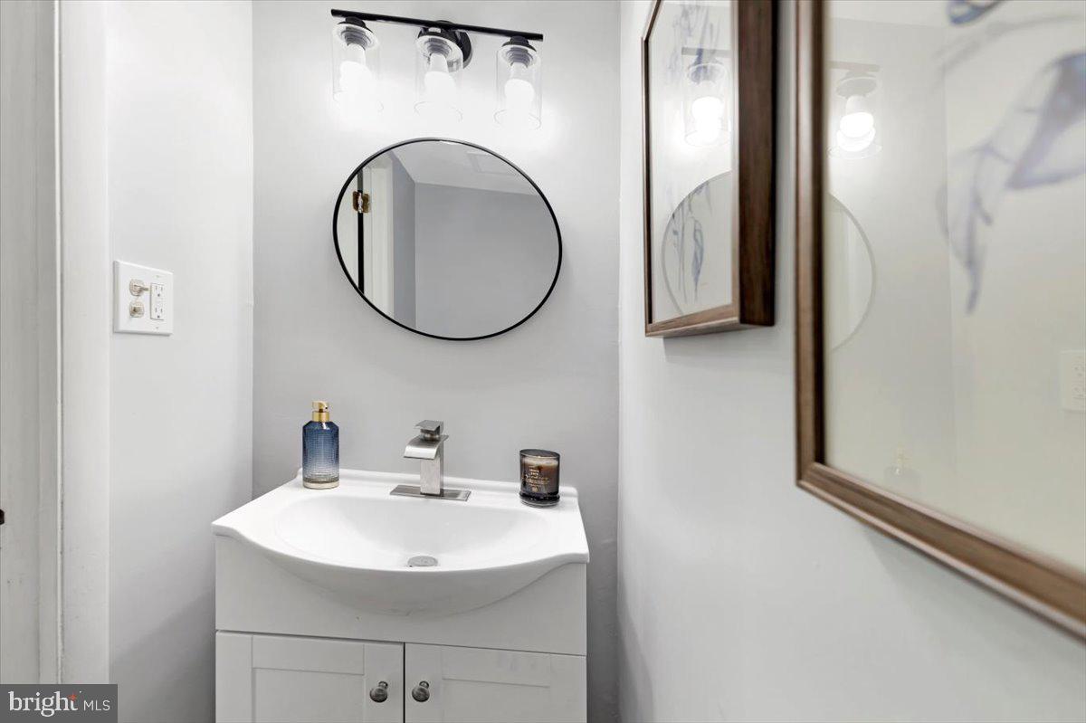 12 Stone Ridge Court Baltimore, MD 21239 - Photo 12 of 38 a bathroom with a sink and a mirror