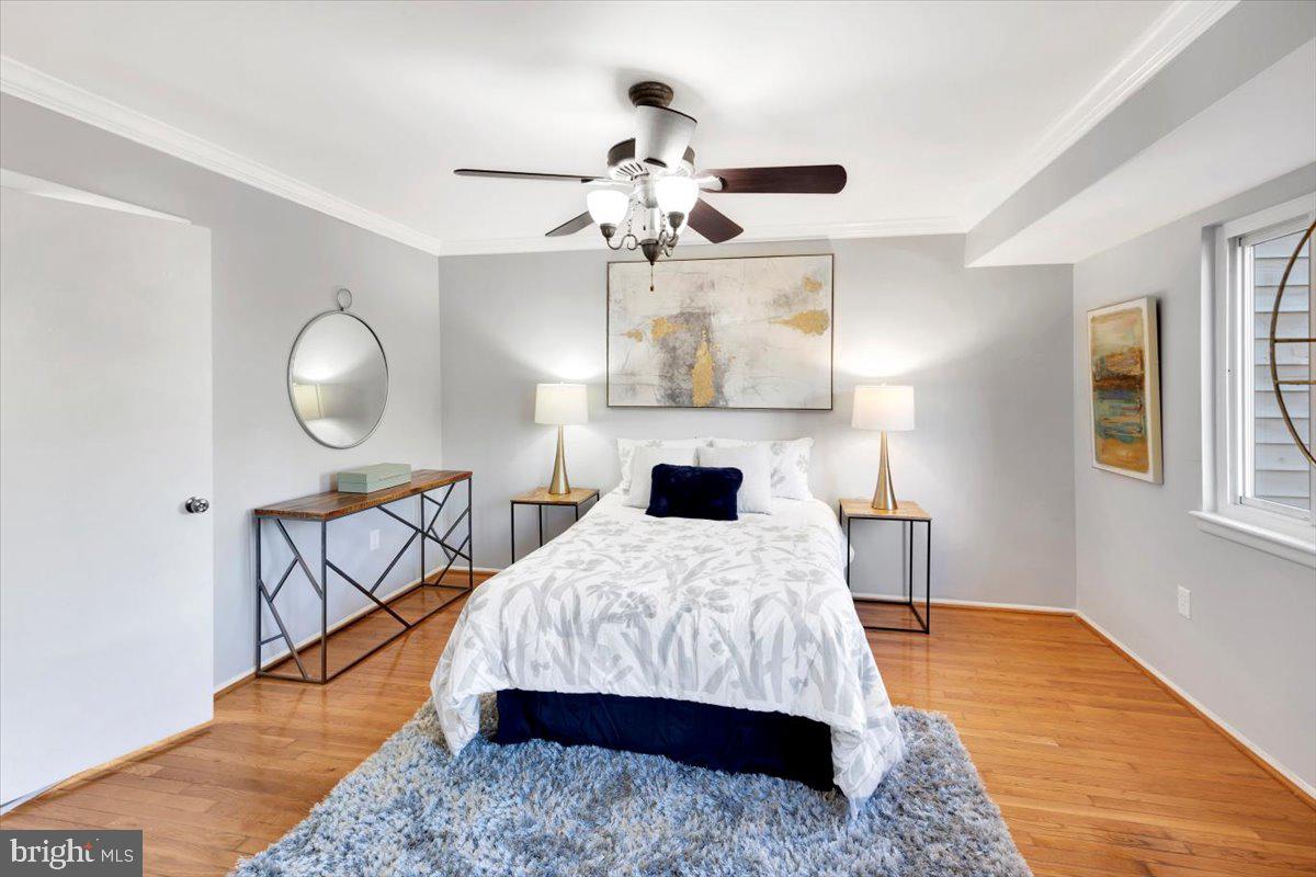 12 Stone Ridge Court Baltimore, MD 21239 - Photo 14 of 38 a bedroom with a bed and a chandelier