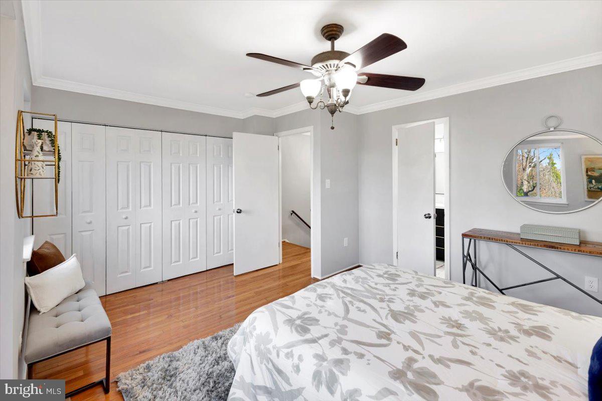 12 Stone Ridge Court Baltimore, MD 21239 - Photo 15 of 38 a bedroom with a large bed and a chandelier