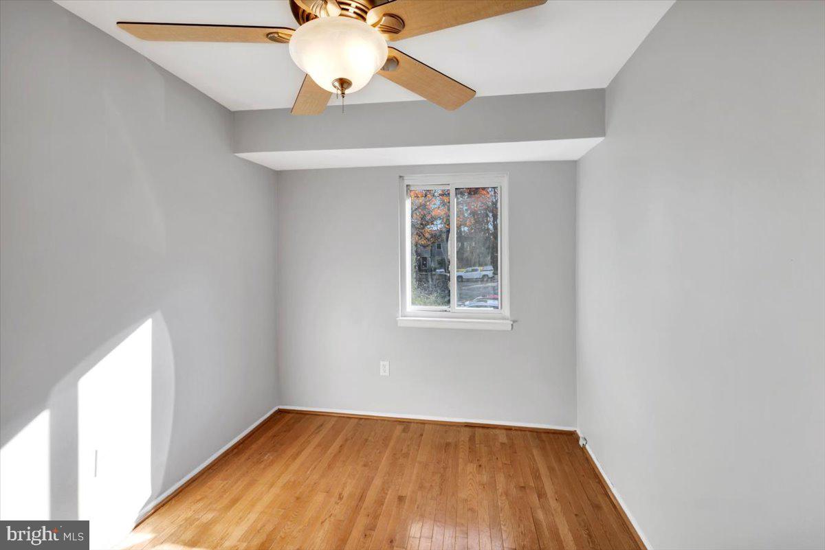 12 Stone Ridge Court Baltimore, MD 21239 - Photo 22 of 38 an empty room with a window and wooden floor