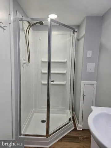 a bathroom with a glass shower door