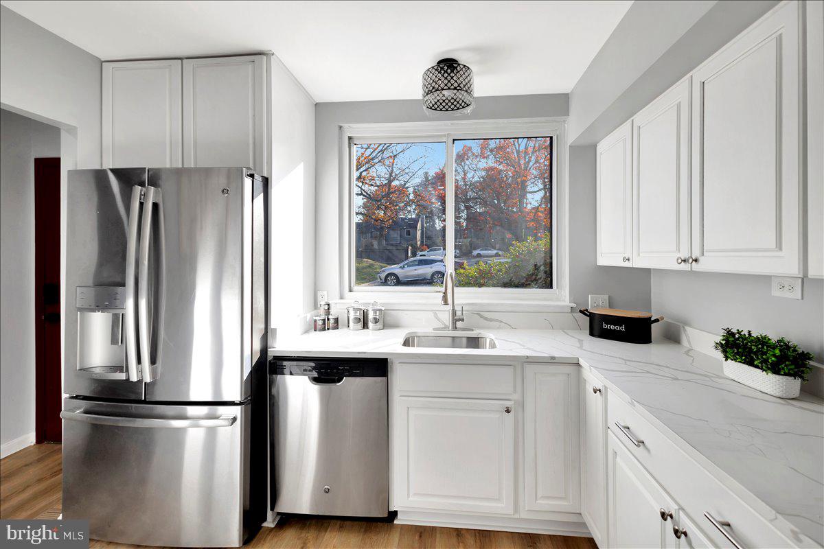 12 Stone Ridge Court Baltimore, MD 21239 - Photo 6 of 38 a kitchen with stainless steel appliances a refrigerator sink and cabinets