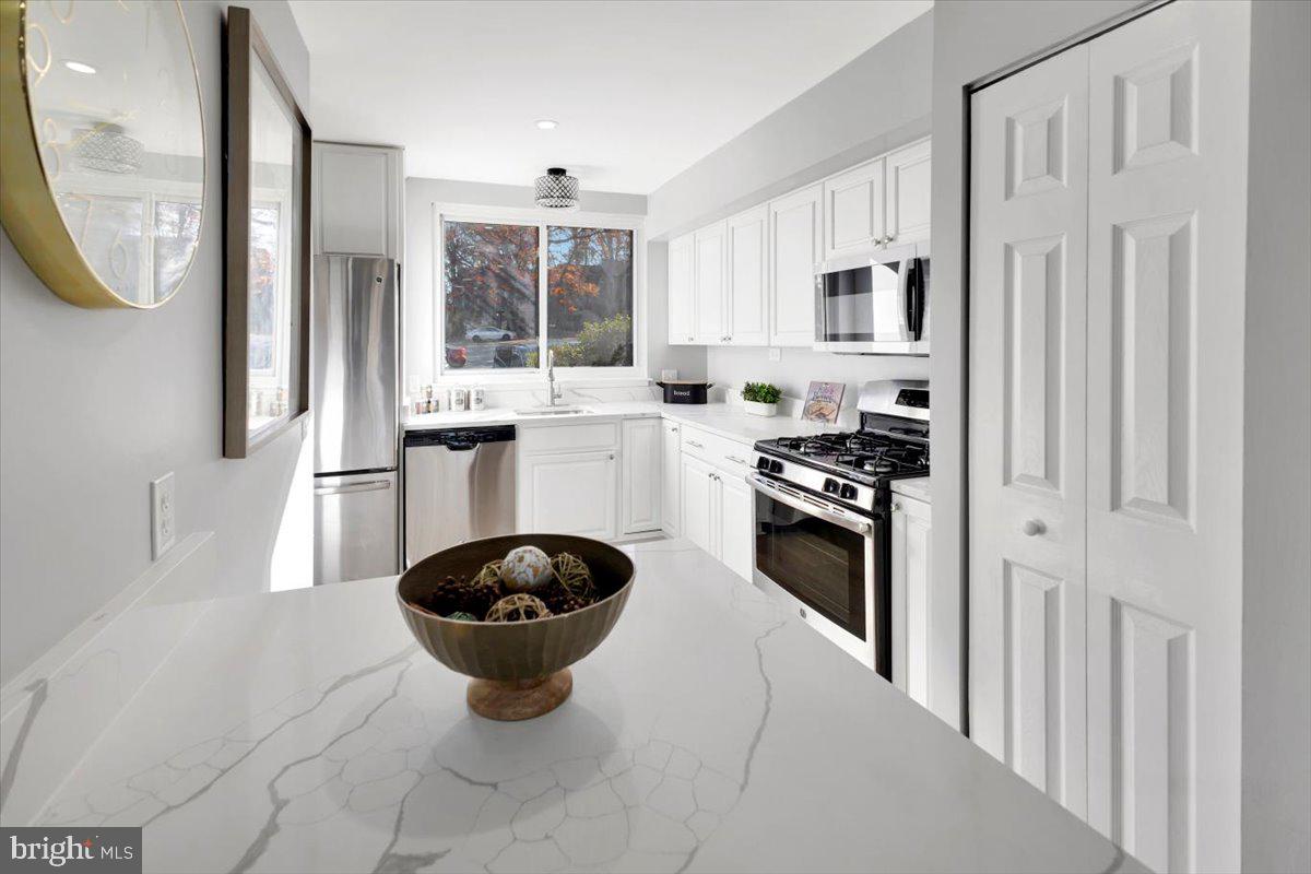 12 Stone Ridge Court Baltimore, MD 21239 - Photo 9 of 38 a kitchen with stainless steel appliances a stove a sink and a refrigerator