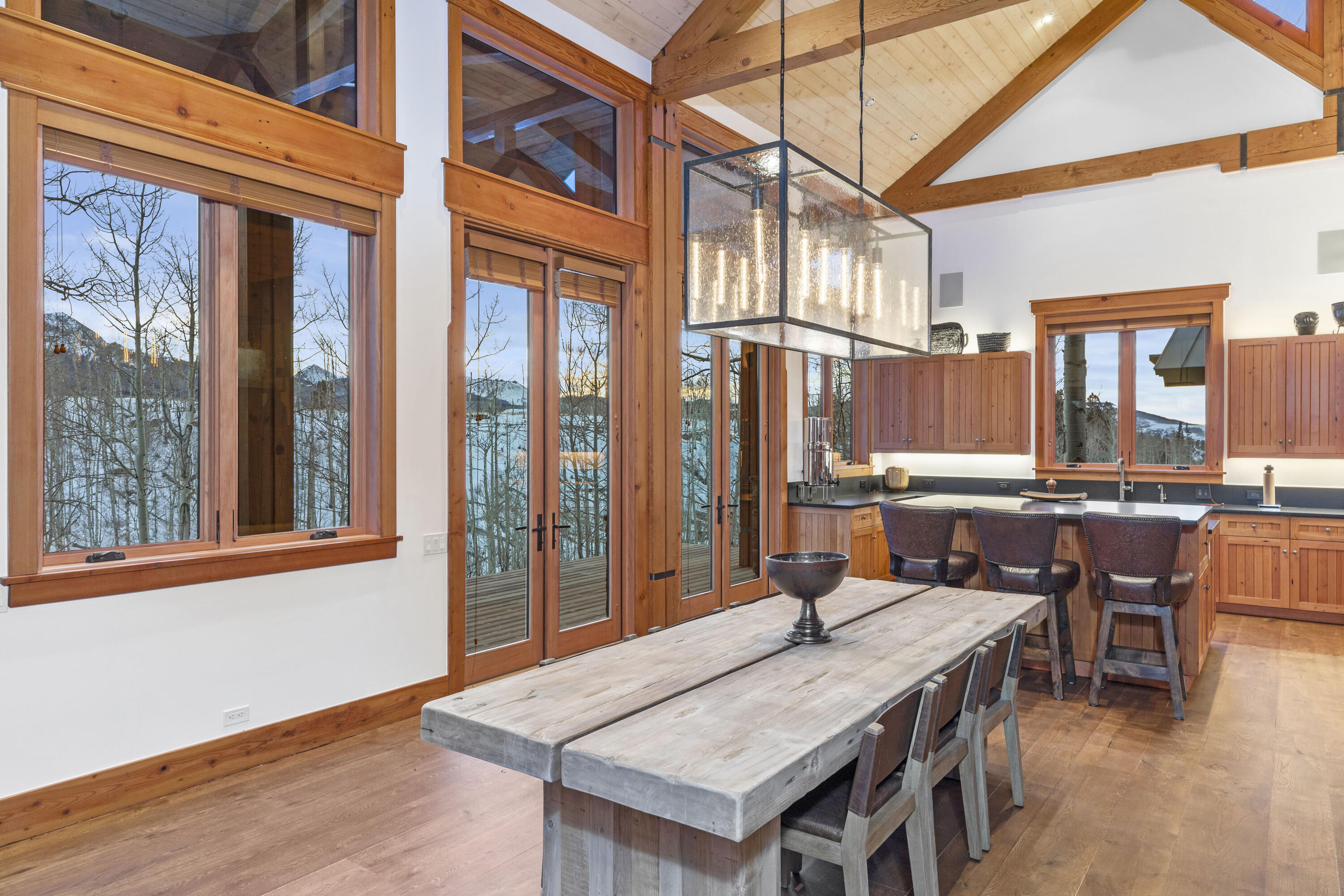6800 County Road Telluride, CO 81435 - Photo 19 of 64 a view of a dining room with furniture window and wooden floor