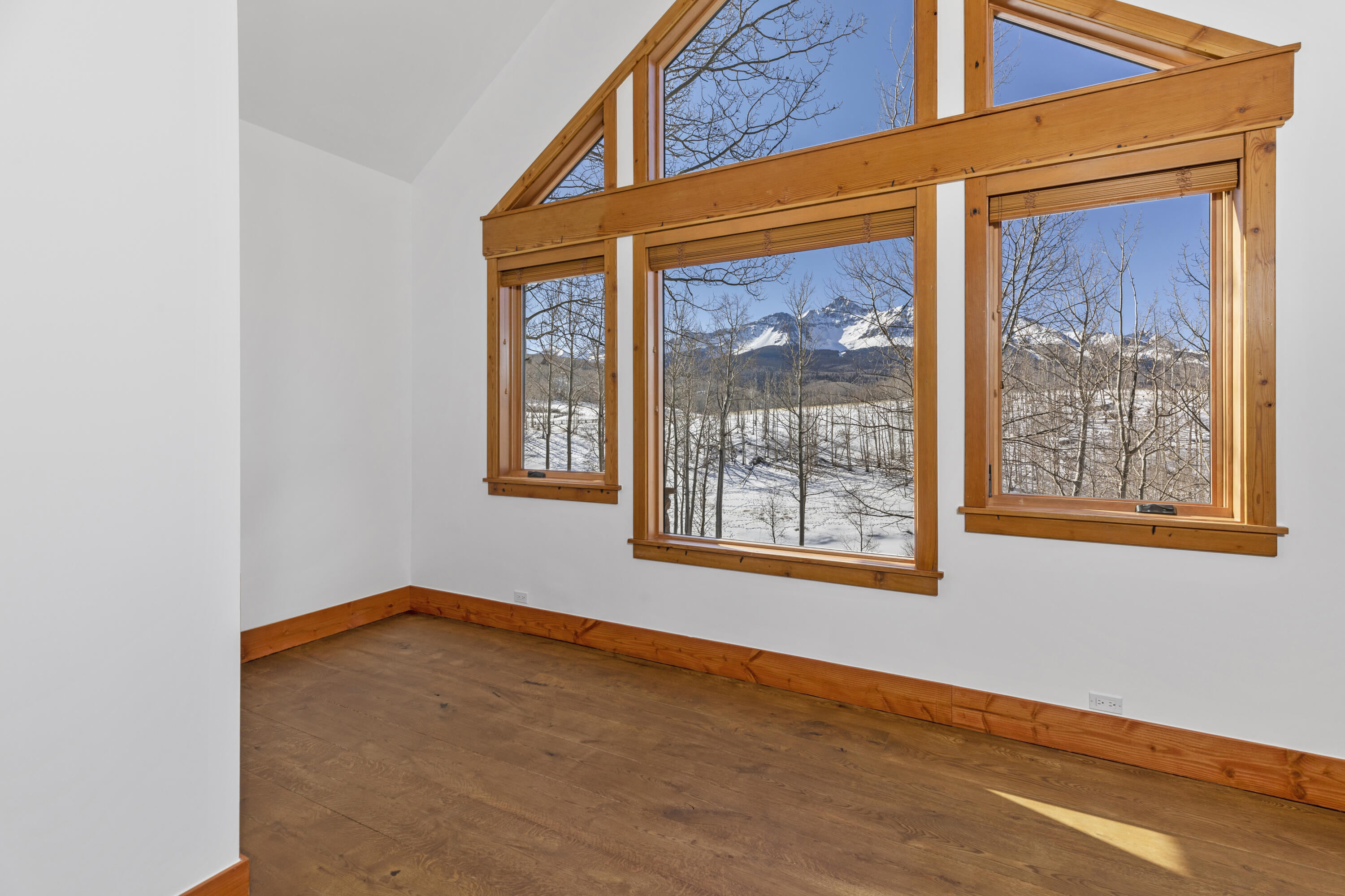 6800 County Road Telluride, CO 81435 - Photo 38 of 64 a view of an empty room with wooden floor and a window