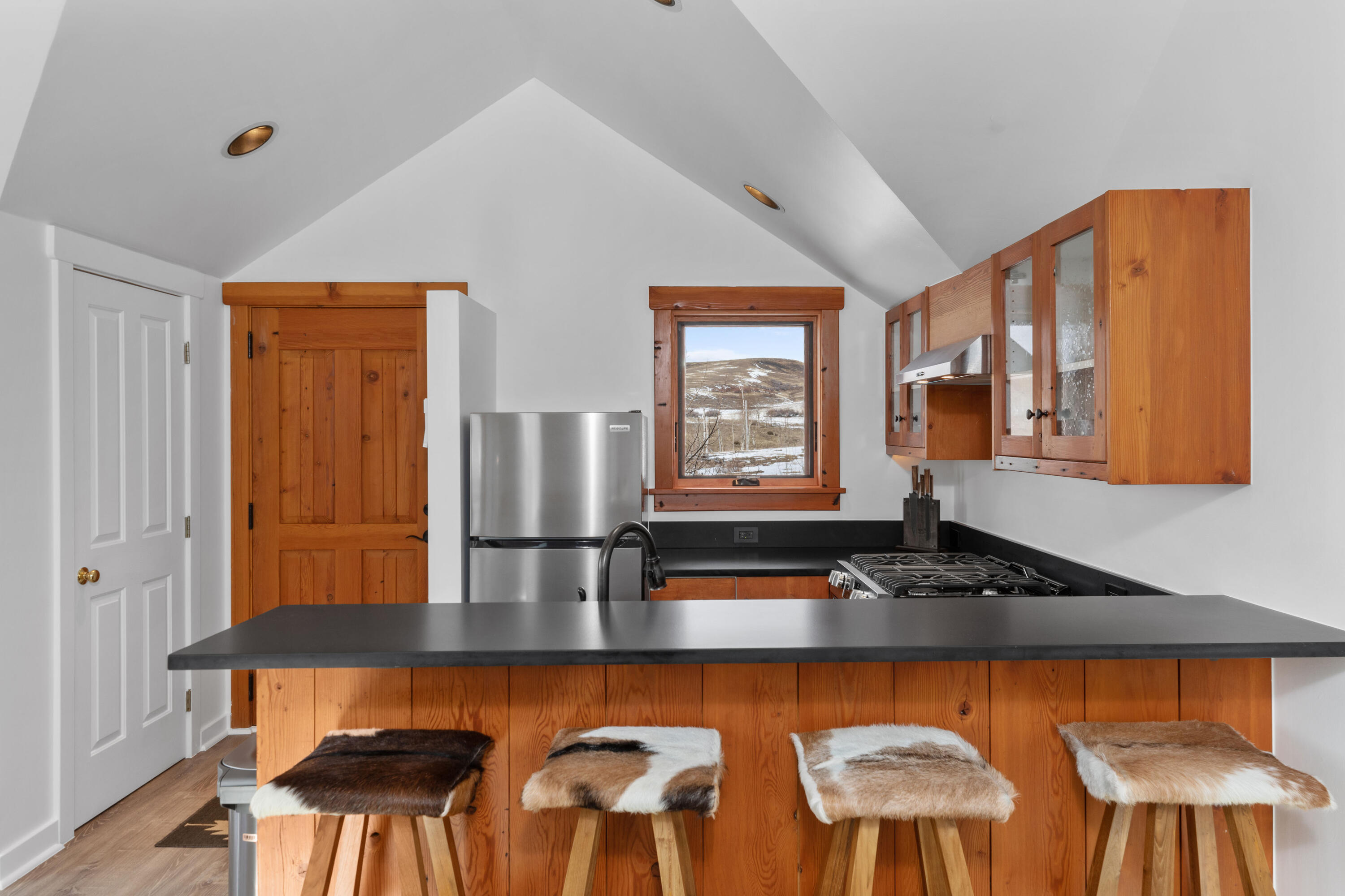 6800 County Road Telluride, CO 81435 - Photo 55 of 64 a kitchen with a table chairs and wooden floor