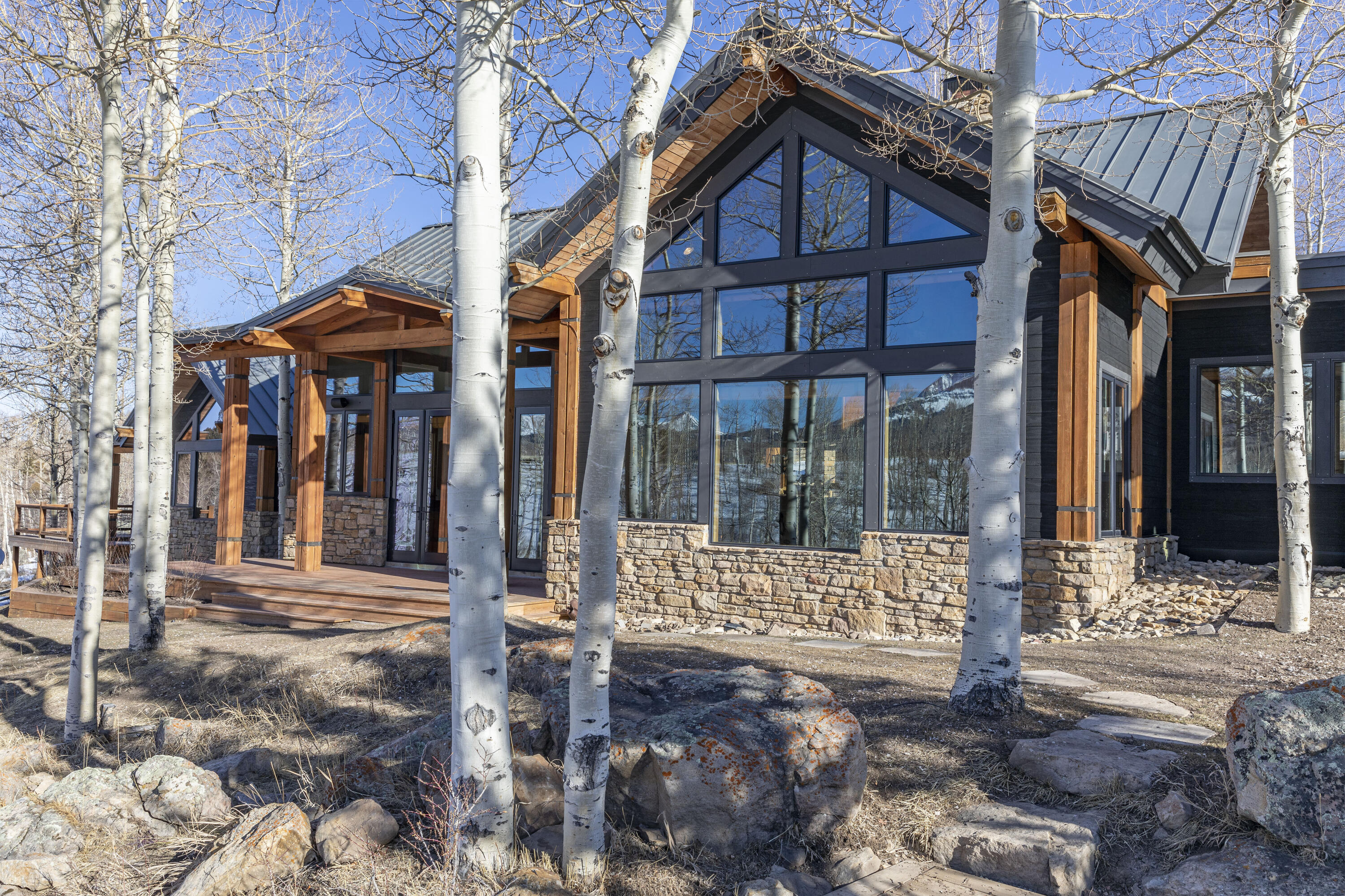 6800 County Road Telluride, CO 81435 - Photo 6 of 64 a view of brick house with large windows