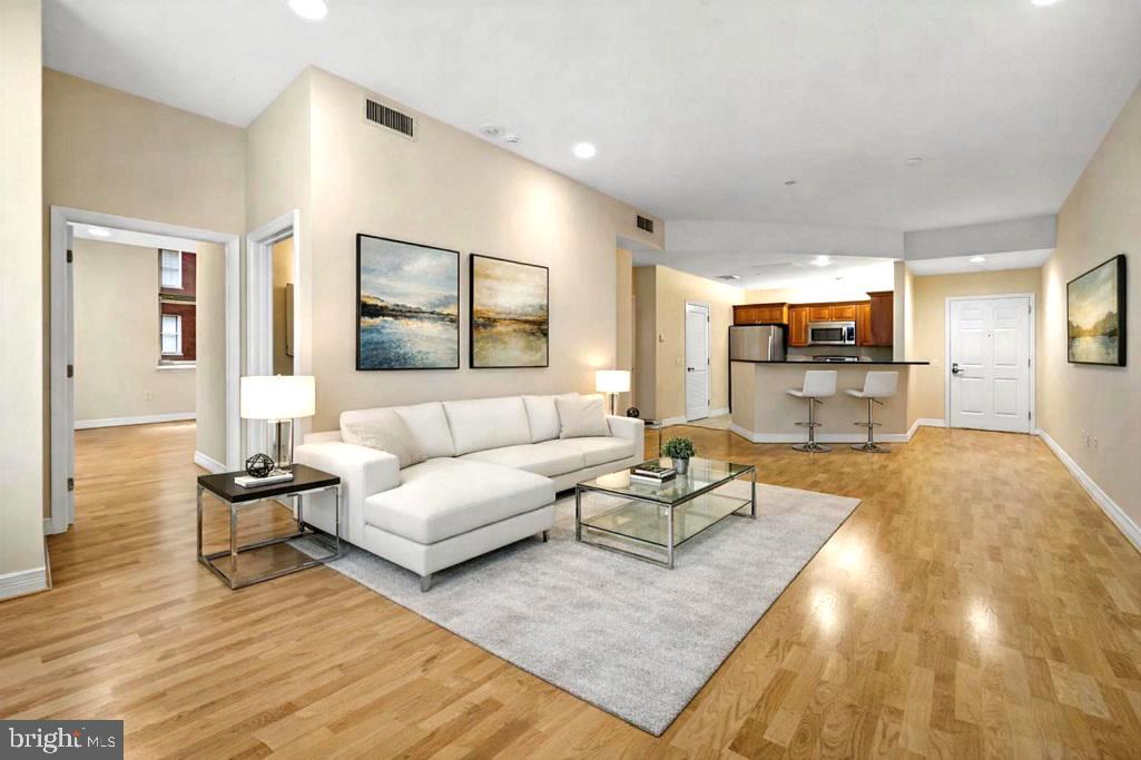 1600 Arch Street, Unit 1116 Philadelphia, PA 19103 - Photo 1 of 23 a living room with furniture and a wooden floor