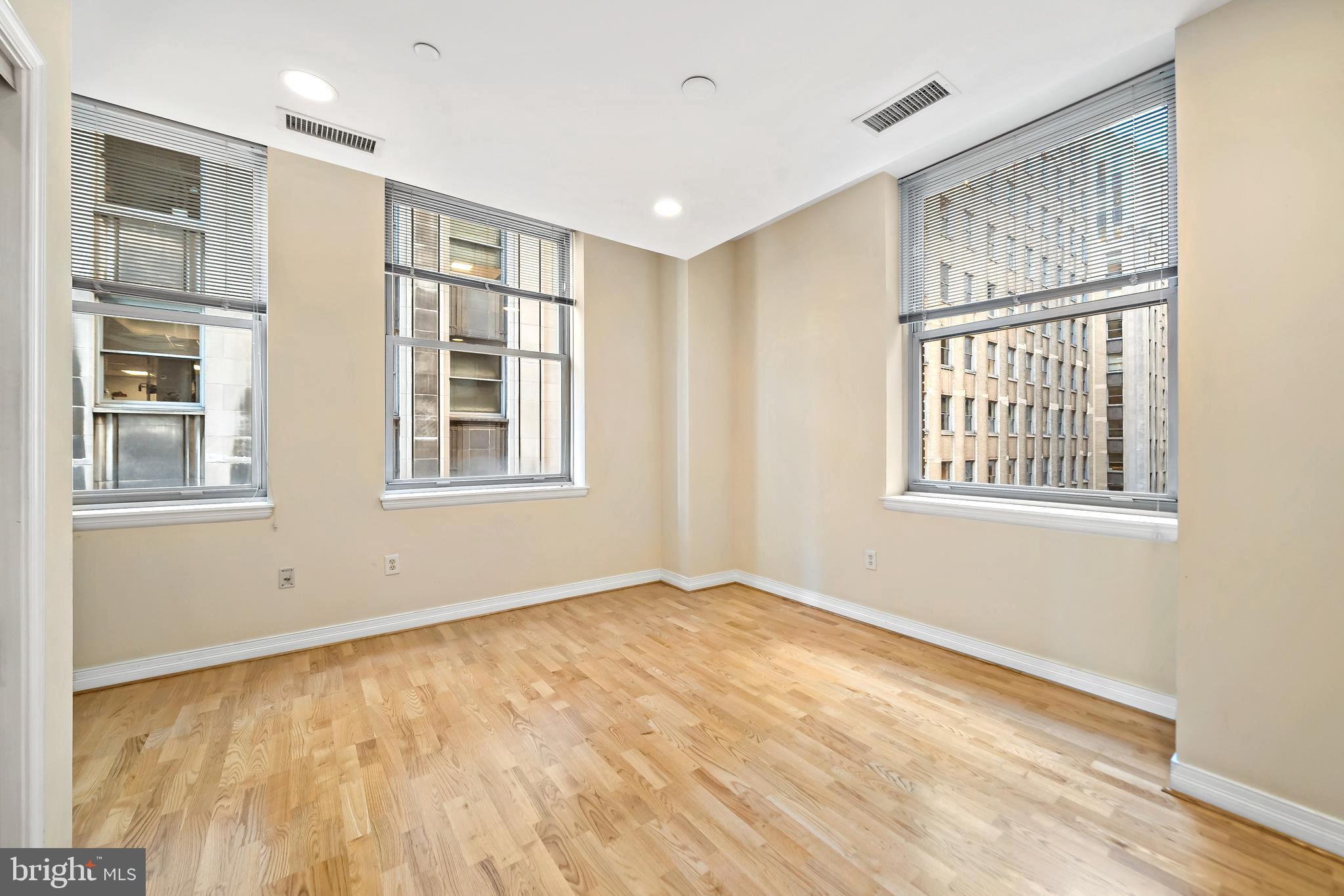 1600 Arch Street, Unit 1116 Philadelphia, PA 19103 - Photo 12 of 23 a view of an empty room with a window and wooden floor
