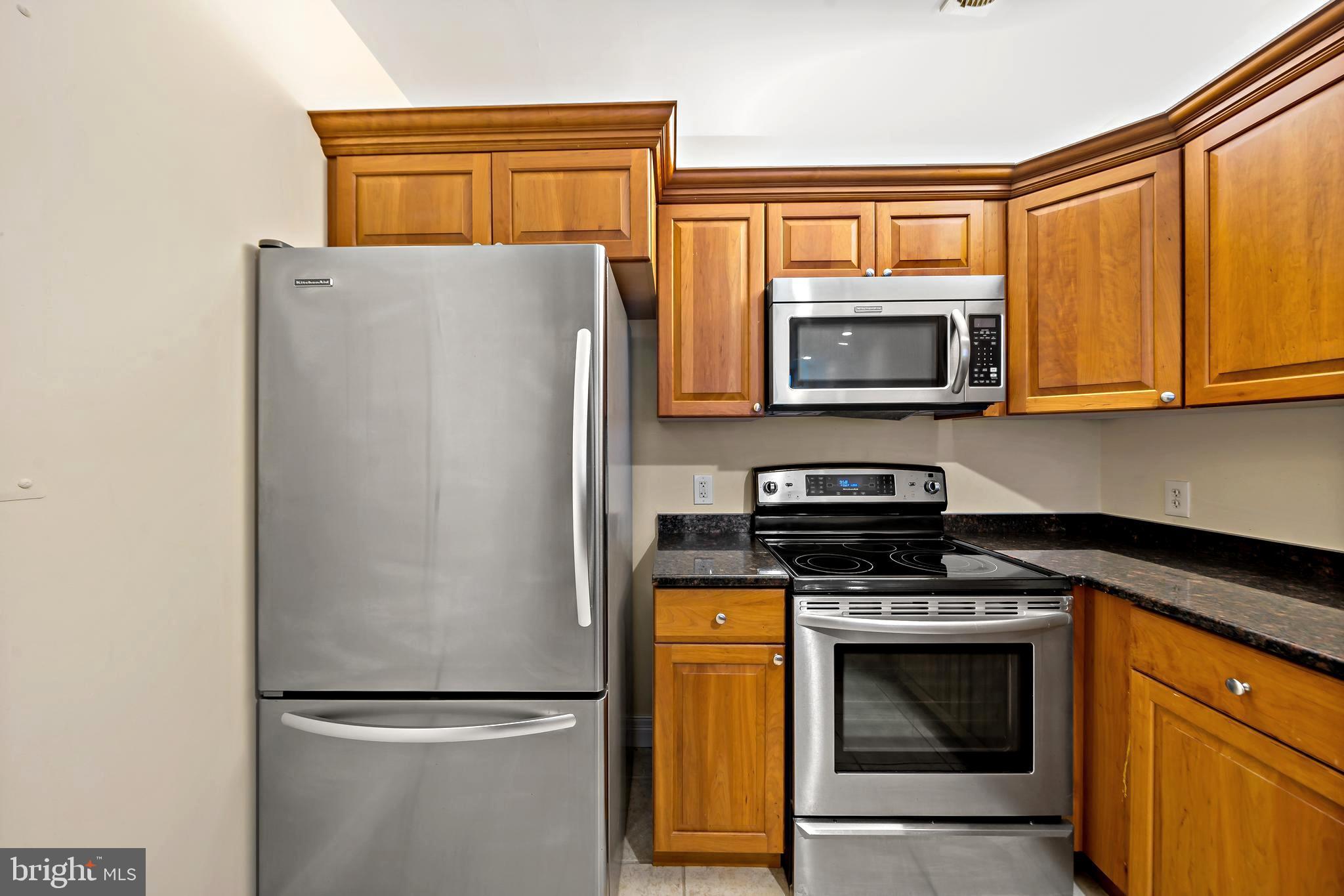 1600 Arch Street, Unit 1116 Philadelphia, PA 19103 - Photo 3 of 23 a kitchen with a refrigerator stove and microwave