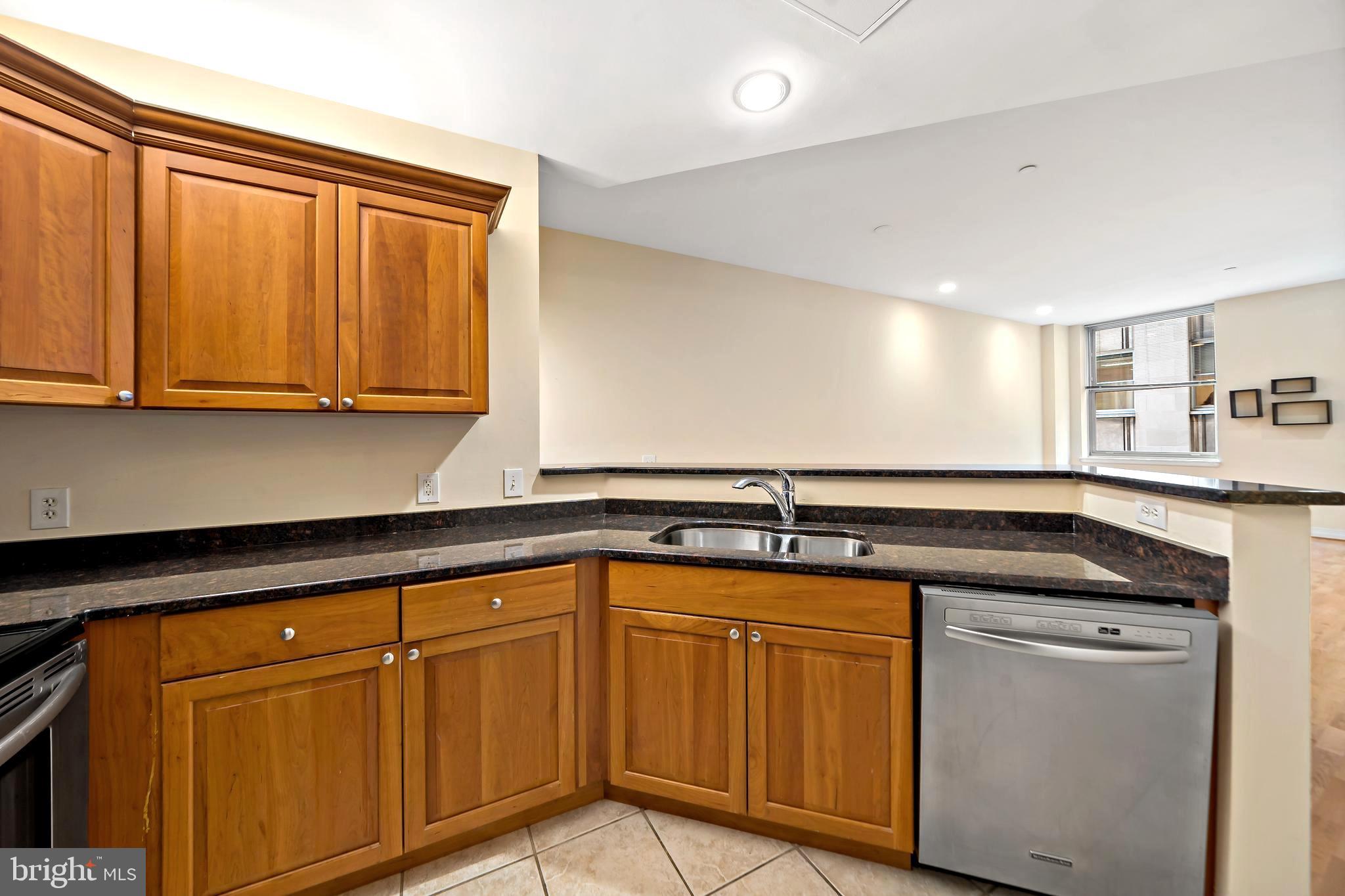 1600 Arch Street, Unit 1116 Philadelphia, PA 19103 - Photo 4 of 23 a kitchen with granite countertop a sink and cabinets