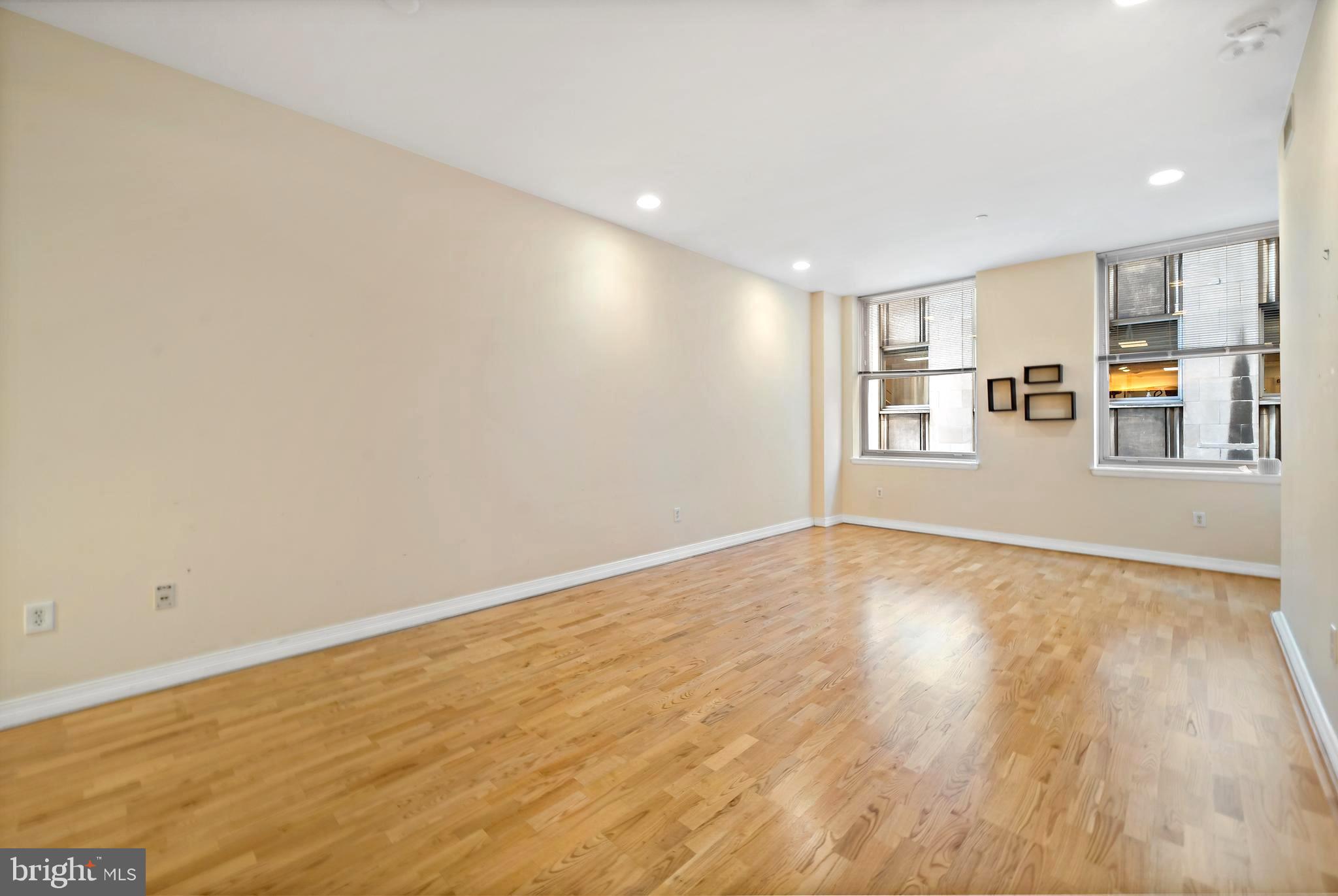 1600 Arch Street, Unit 1116 Philadelphia, PA 19103 - Photo 7 of 23 a view of an empty room with wooden floor and a window