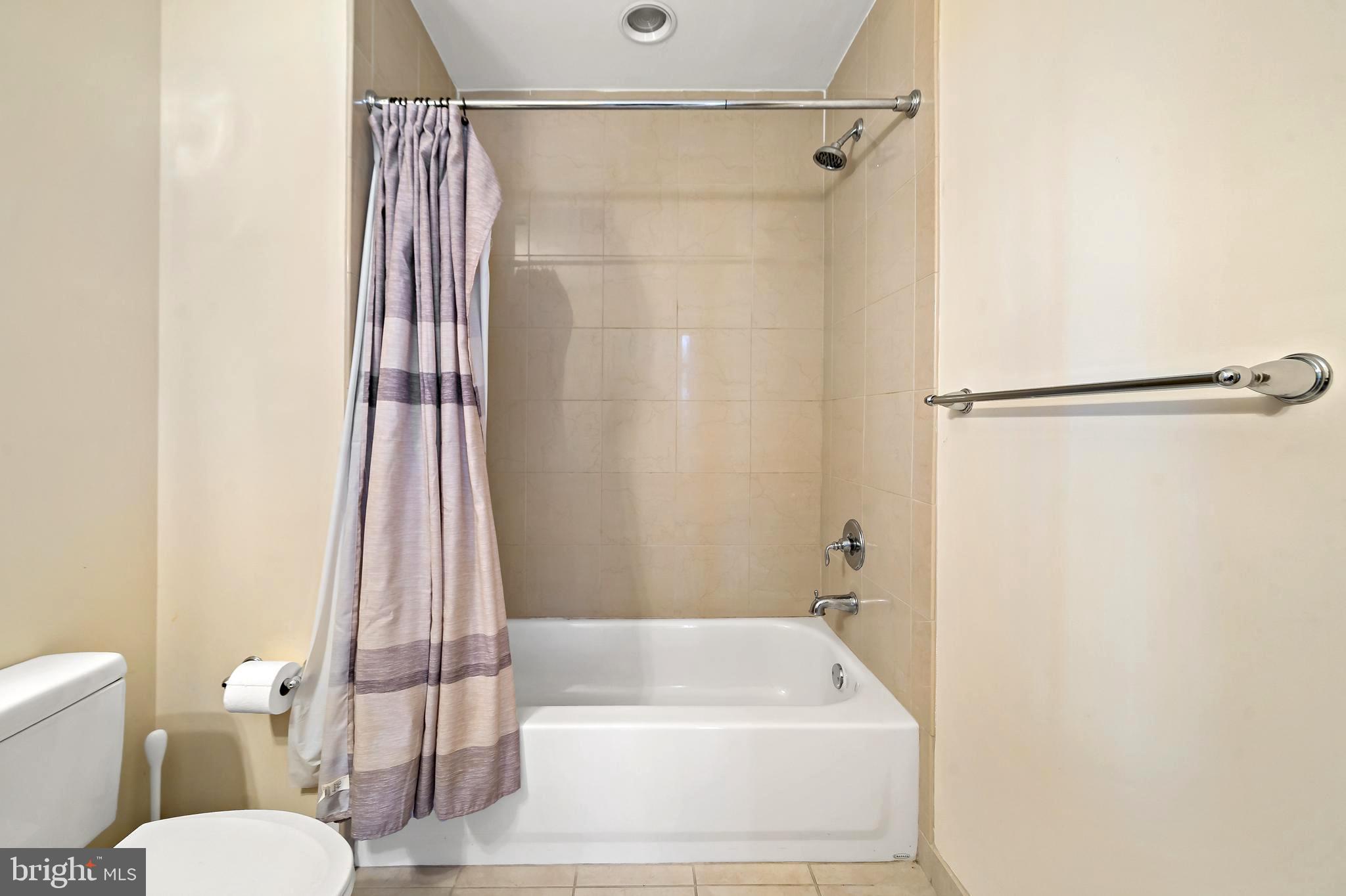 1600 Arch Street, Unit 1116 Philadelphia, PA 19103 - Photo 10 of 23 a white bath tub sitting next to a white toilet