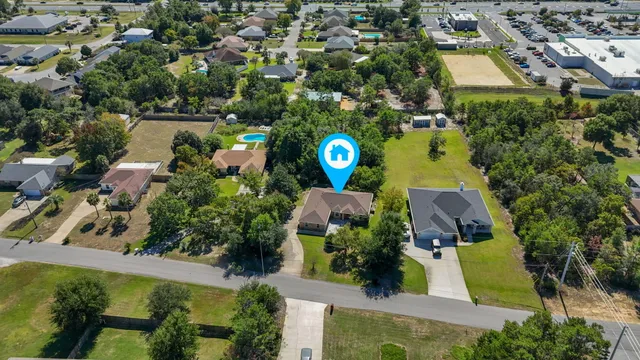 an aerial view of a house with a yard and lake view