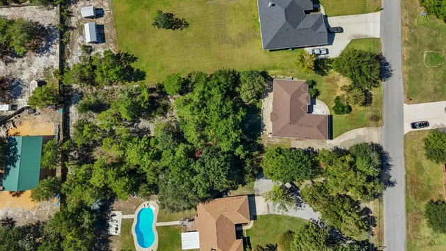 an aerial view of a house with a yard swimming pool and outdoor seating