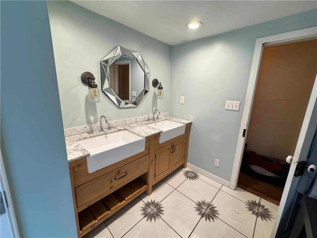 108 Effort Neola Road Effort, PA 18330 - Photo 22 of 31 A well-appointed bathroom offers dual farmhouse sinks and elegant tiled flooring.