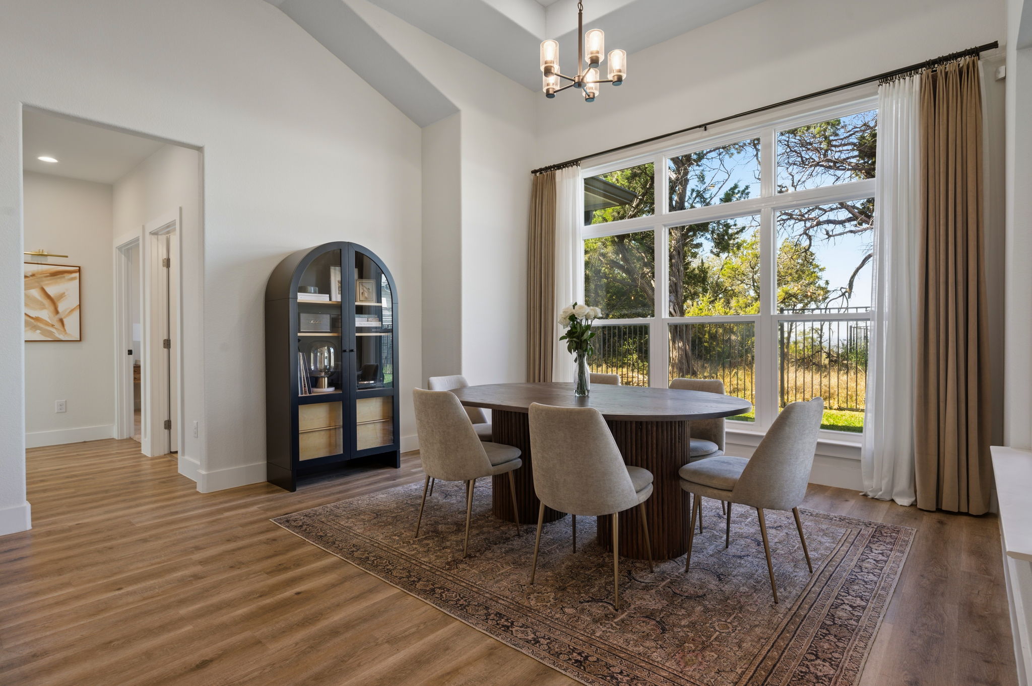8604 Bar K Ranch Road Lago Vista, TX 78645 - Photo 12 of 37 Dining room featuring hanging lights and dark wood-style floors