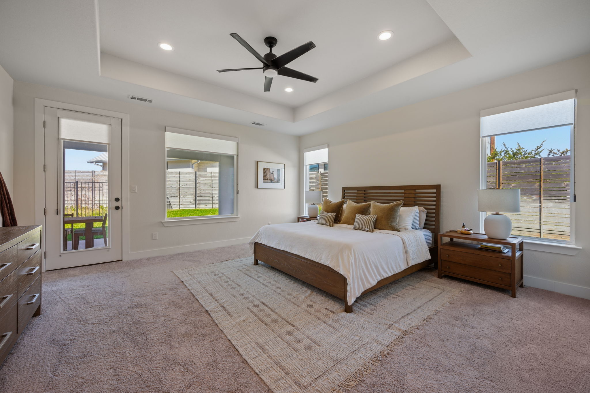 8604 Bar K Ranch Road Lago Vista, TX 78645 - Photo 15 of 37 Bedroom featuring light carpet, a ceiling fan, recessed lighting, and access to outside