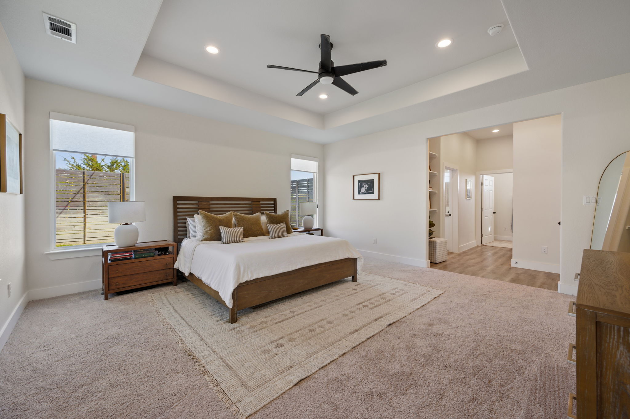 8604 Bar K Ranch Road Lago Vista, TX 78645 - Photo 16 of 37 Bedroom with light carpet, recessed lighting, a ceiling fan, and multiple windows