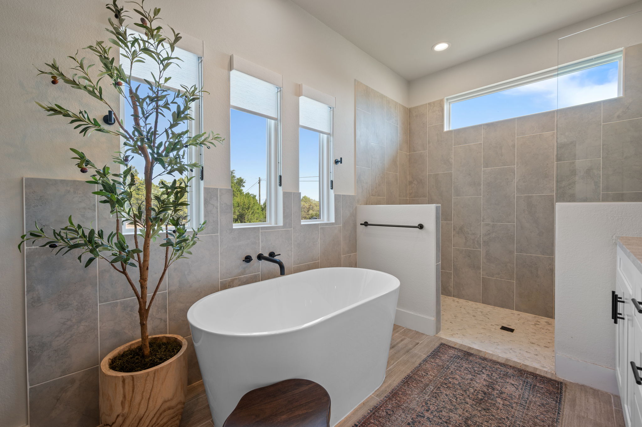 8604 Bar K Ranch Road Lago Vista, TX 78645 - Photo 18 of 37 Bathroom featuring a freestanding tub, vanity, tile walls, a walk in shower, and recessed lighting