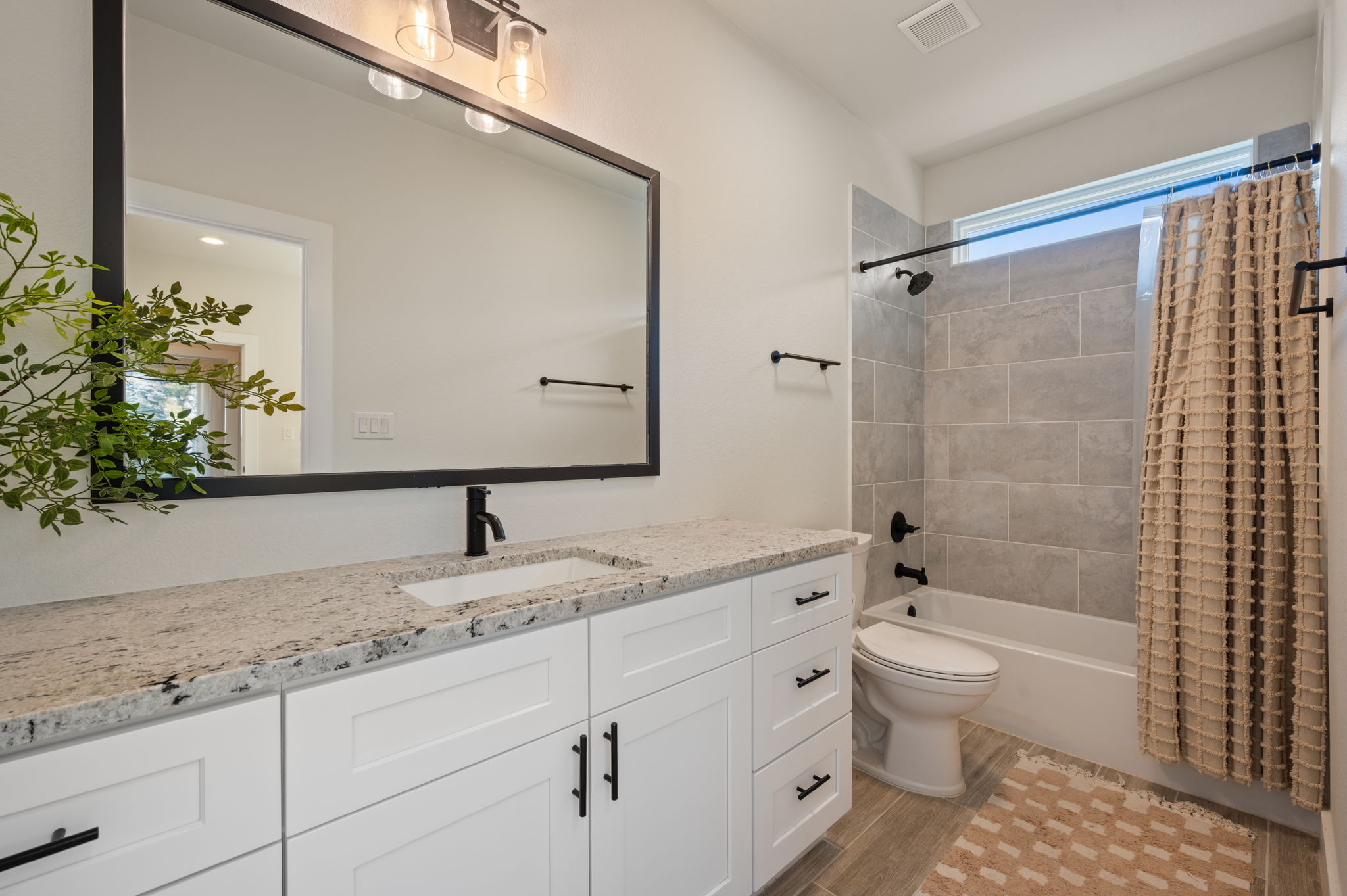 8604 Bar K Ranch Road Lago Vista, TX 78645 - Photo 23 of 37 Full bath featuring vanity, shower / bath combination with curtain, and wood finish floors