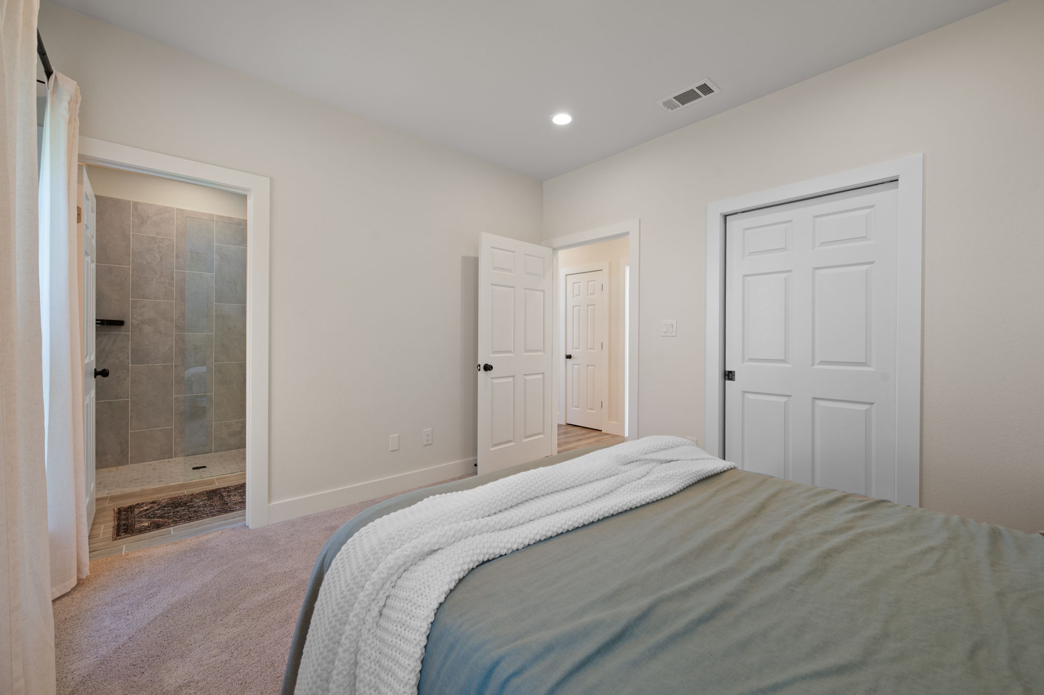 8604 Bar K Ranch Road Lago Vista, TX 78645 - Photo 25 of 37 Carpeted bedroom featuring recessed lighting and ensuite bath