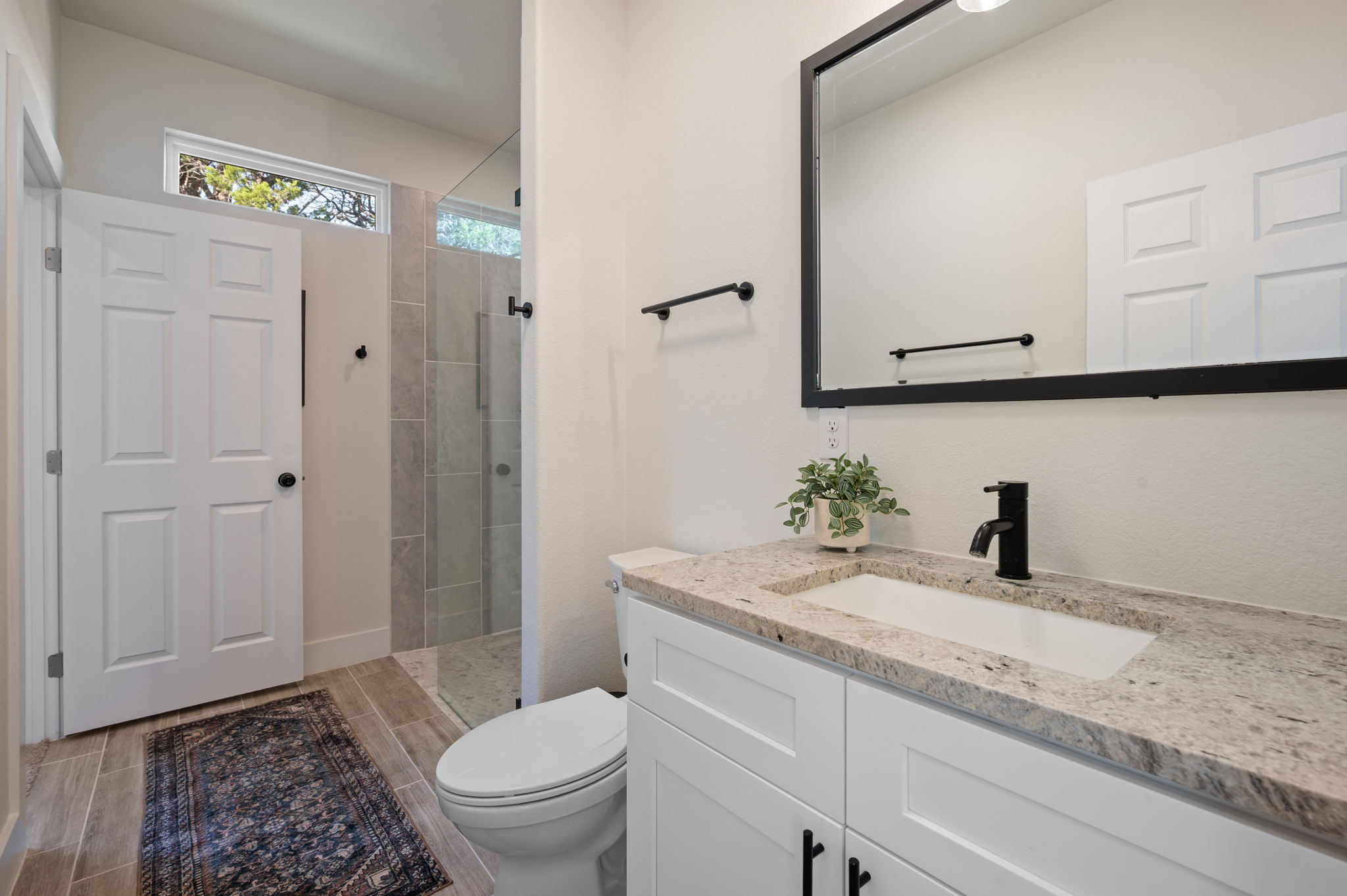 8604 Bar K Ranch Road Lago Vista, TX 78645 - Photo 27 of 37 Full bath with vanity, walk in shower, and wood tiled floors