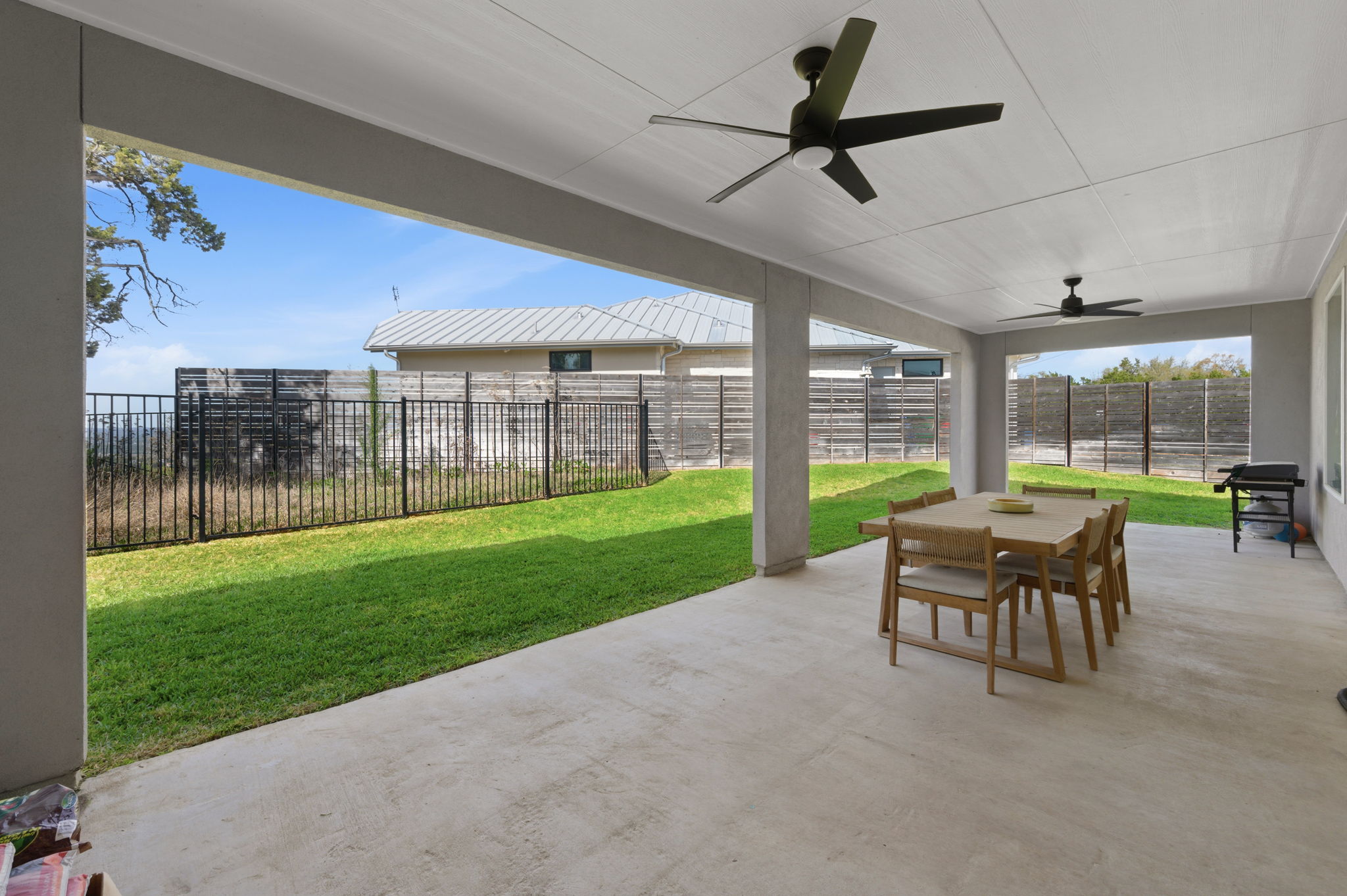 8604 Bar K Ranch Road Lago Vista, TX 78645 - Photo 30 of 37 Fenced backyard featuring outdoor dining area, a patio, and ceiling fan