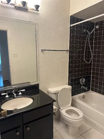 a bathroom with a sink toilet mirror and shower