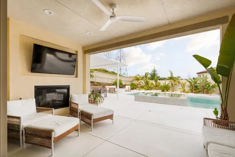 a living room with fireplace furniture and a flat screen tv