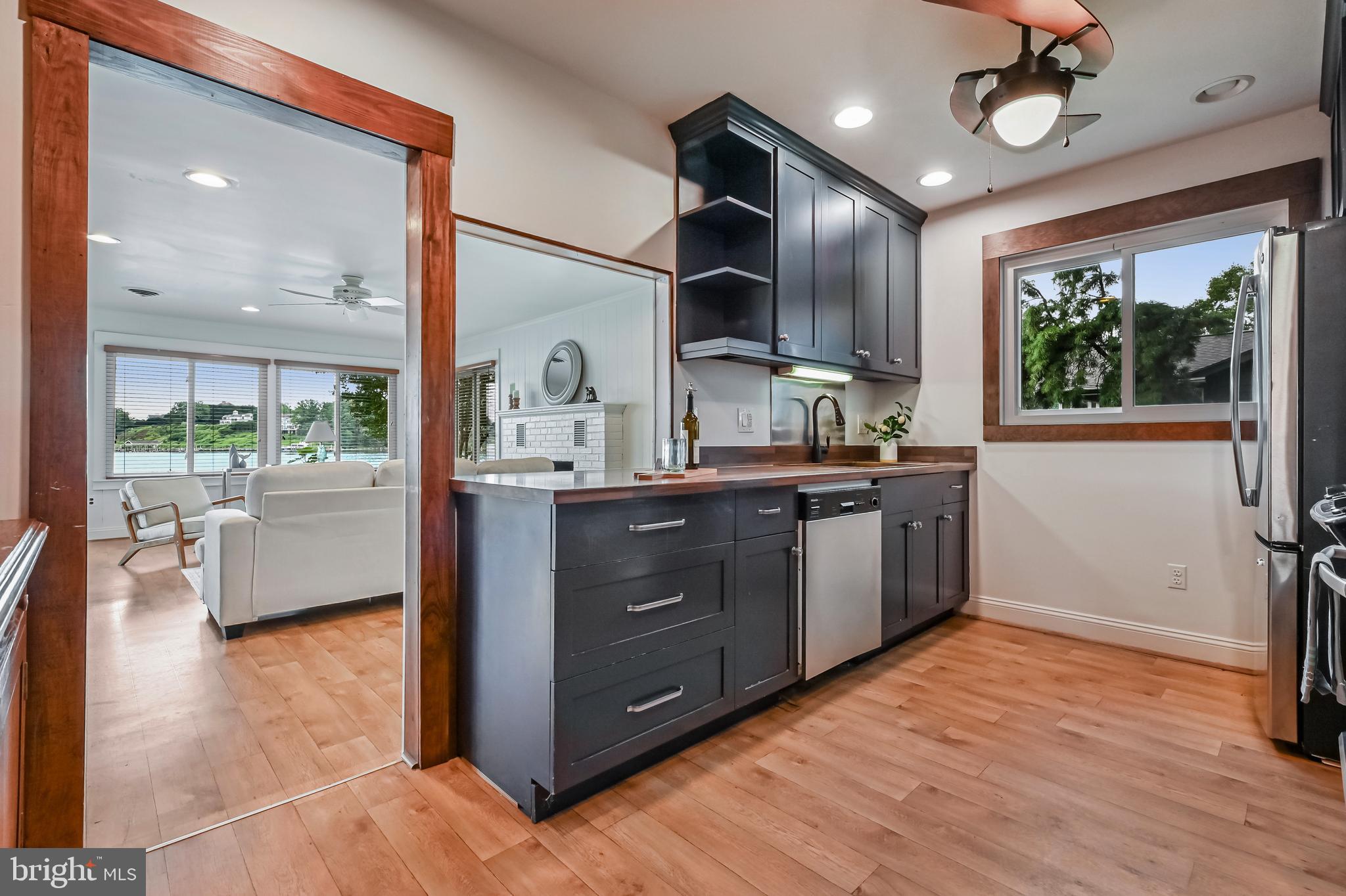 769 Robin Hood Road Annapolis, MD 21405 - Photo 29 of 79 a kitchen with stainless steel appliances granite countertop wooden cabinets a stove a sink and a large window